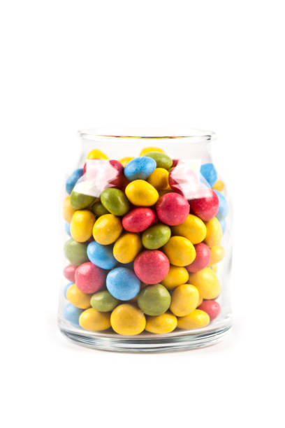 Colorful sweet candies in glass jar isolated on white. stock photo