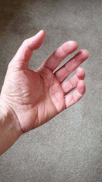 istock Close up of hand on grey textured background with copy space 1152901677