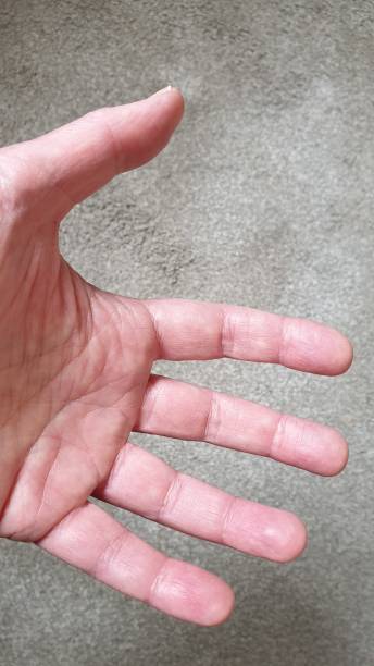 istock Close up of hand on grey textured background with copy space 1152901685