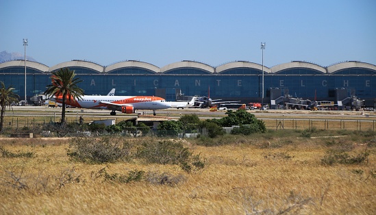 El Altet, Elche, Alicante, Spain- May 30, 2019: Panoramic view of the airport of Alicante in a sunny day of Spring. Planes of different companies landing and taking off