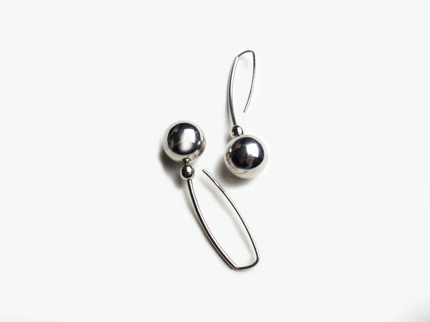 istock Two round white gold earrings on a white background 1152909491