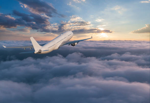 istock Passenger jet airplane flying above clouds at sunset 1152909524