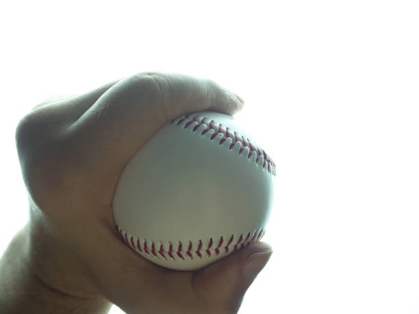 istock Baseball ball in male hand on white background 1152909610
