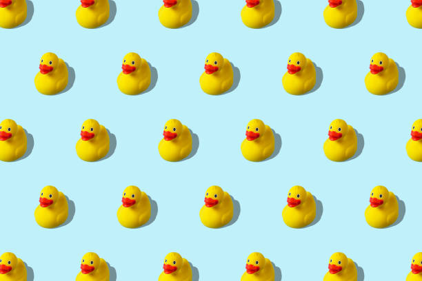 istock Trendy summer pattern with yellow rubber duck on bright blue background. Minimal summer concept. 1152910347