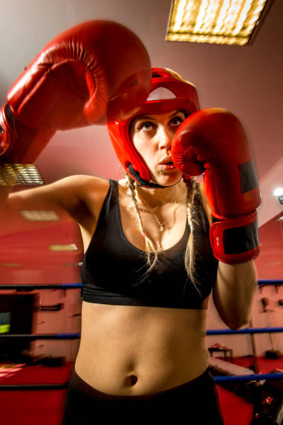 istock Determined Young Woman Exercising in a Gym 1152911557