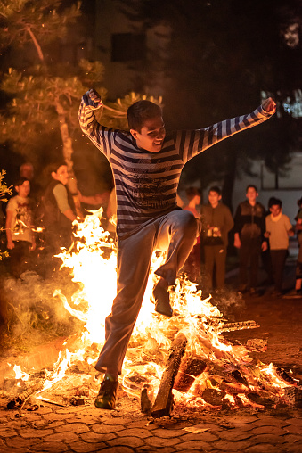Izmir, Turkey - May 5, 2019: Hidirellez night. people have fun with jumping over the fire and making wishes. Hidirellez is celebrated as day on which prophets hizir and ilyas met on the earth at 5-6 May every year.