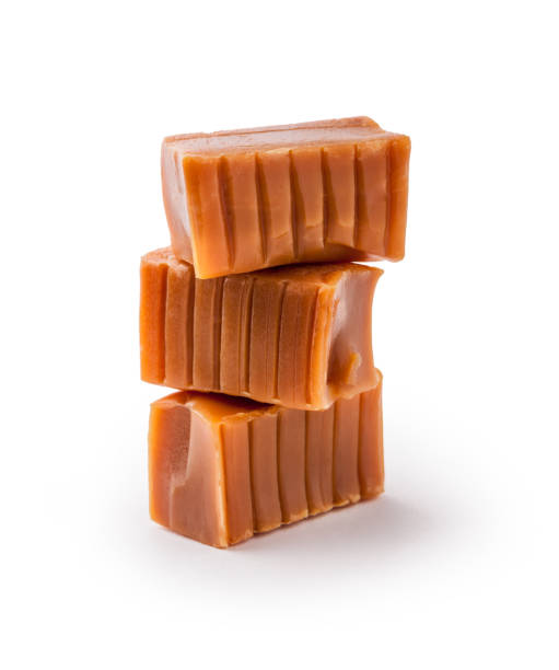 istock Caramels candy cubes stacked arrangement isolated on white in studio 1152920004