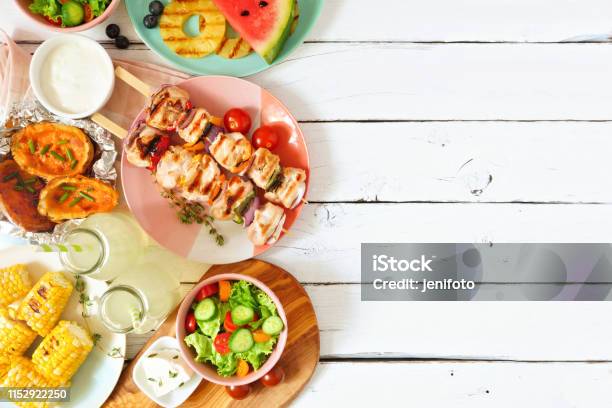 Summer Bbq Or Picnic Food Side Border Above View Over A White Wood Background Stock Photo - Download Image Now