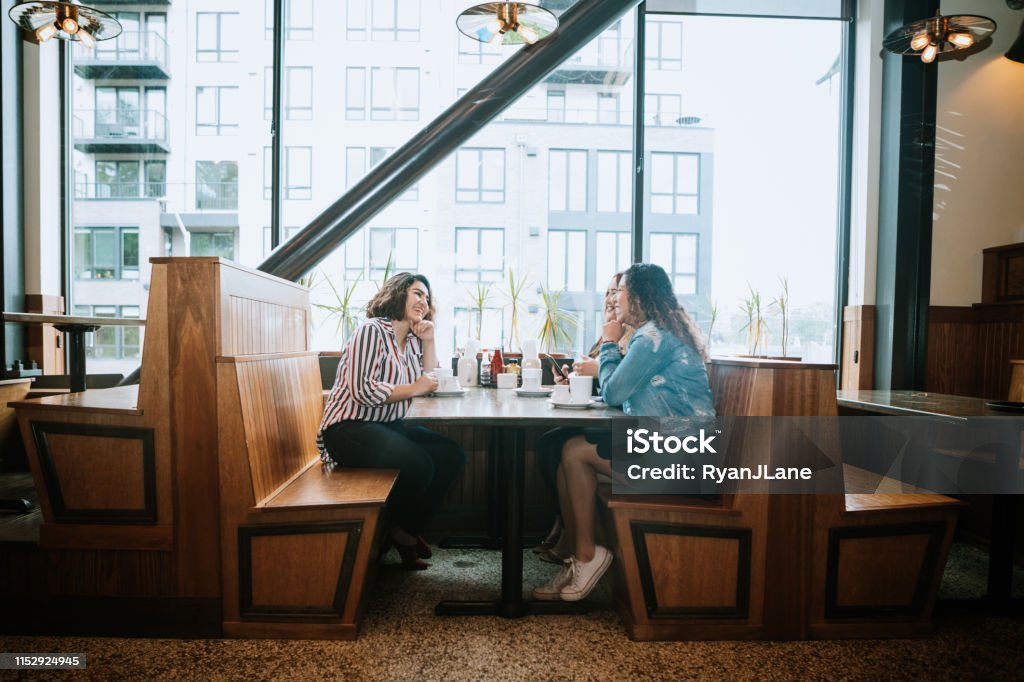 Group of Latina Friends out for Brunch Three Hispanic women enjoy coffee at a cafe diner, having fun sharing life experiences and memories. 
 Shot in Tacoma, Washington. Restaurant Stock Photo