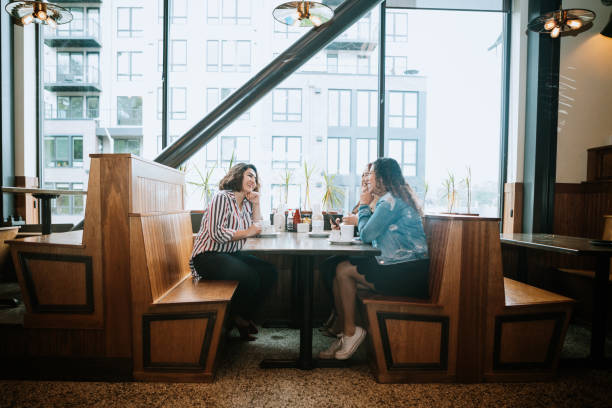Group of Latina Friends out for Brunch Three Hispanic women enjoy coffee at a cafe diner, having fun sharing life experiences and memories. 
 Shot in Tacoma, Washington. tacoma photos stock pictures, royalty-free photos & images
