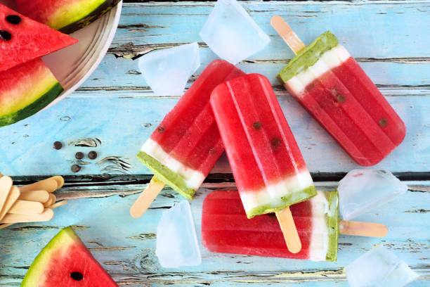 istock Healthy summer watermelon popsicles, top view over rustic blue wood 1152925140