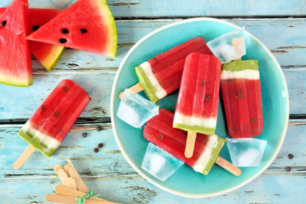 istock Homemade summer watermelon popsicles on a plate, top view over rustic blue wood 1152925246