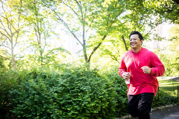 istock Mature Hispanic Man Jogging in Central Park 1152930366