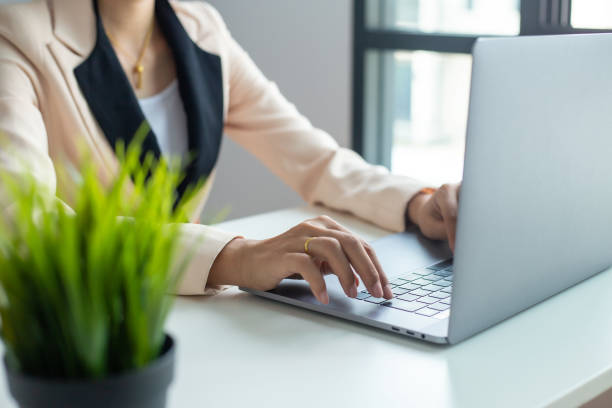 istock Businessman hands busy using laptop at office desk, young female student typing on computer sitting at wooden table 1152934205