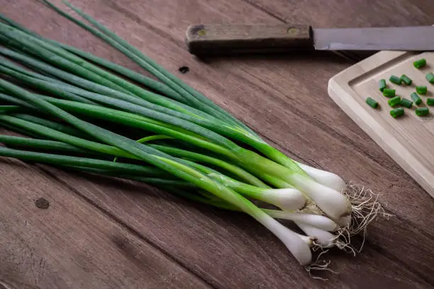 Fresh green onion on wooden table