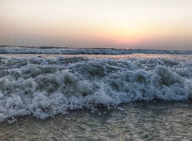 Waves during sunset Sunset time with waves during high tide high tide stock pictures, royalty-free photos & images