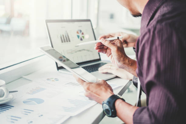 Co-working Business Team Consulting meeting Planning with digital tablet Strategy Analysis investment and saving concept. meeting discussing new plan financial graph data.