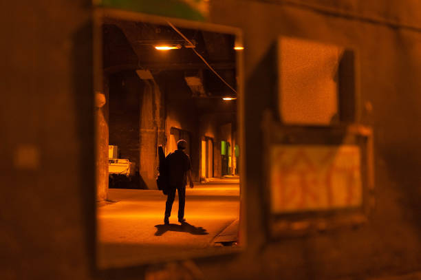 istock Passerby in mirror of orange underpass 1152943799