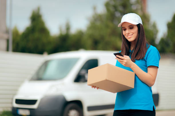 istock Female Delivery Worker Holding Cardboard Box Package 1152946290