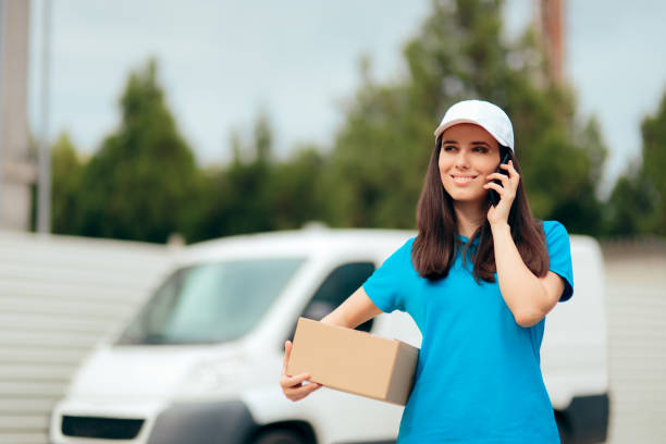 istock Female Delivery Worker Holding Cardboard Box Package 1152946312