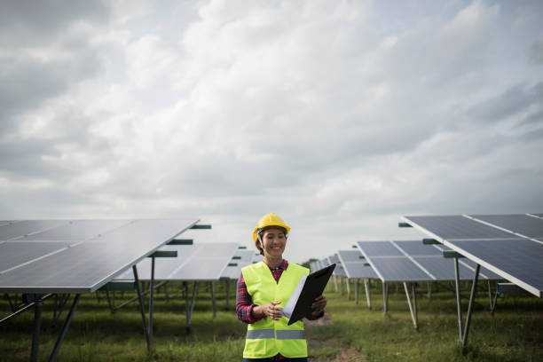 Engineer electric woman checking and maintenance of solar cells. stock photo