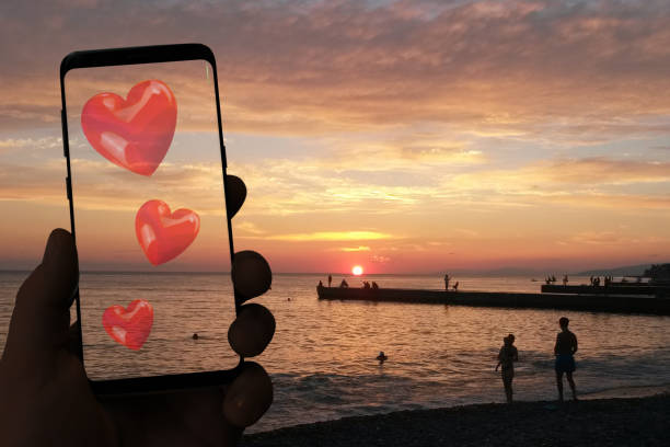 istock male hand  holds smartphone with hearts 1152958501
