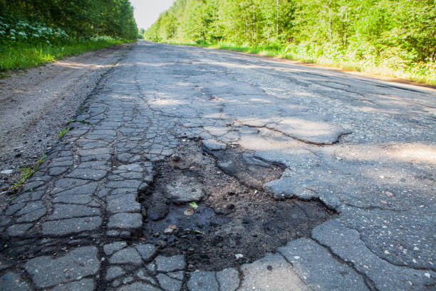 istock Dangerous pothole in the asphalt rural road. Road damage 1152966643