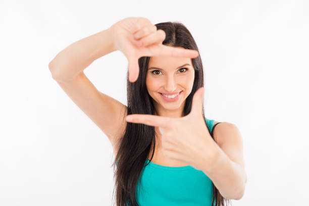 istock happy young woman gesturing finger frame and smiling 1152968541