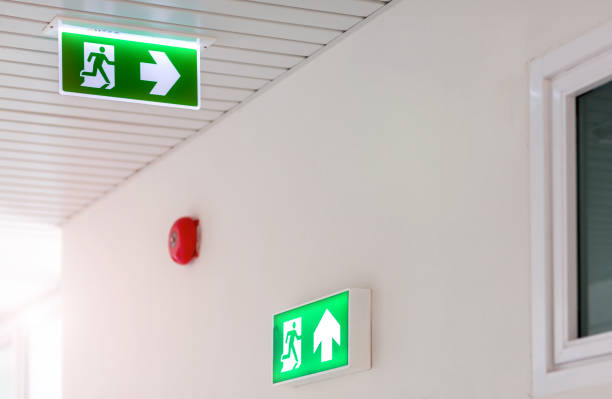 istock Green emergency exit sign showing the way to escape.Fire exit in the building. 1152971277