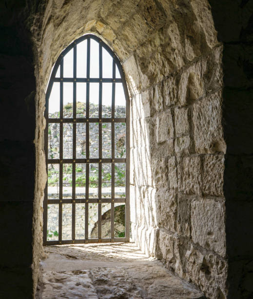 istock Window of an ancient fortress against a brick wall 1152972980