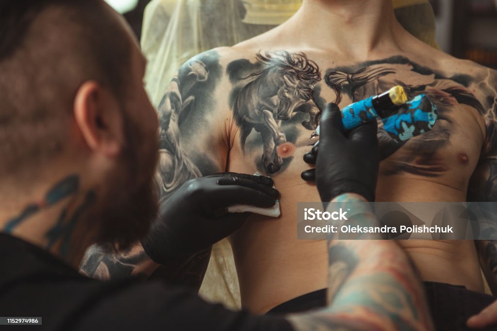 Man Getting New Tattoo By Professional Tattooist Stock Photo - Download  Image Now - Chest - Torso, Tattooing, Adult - iStock