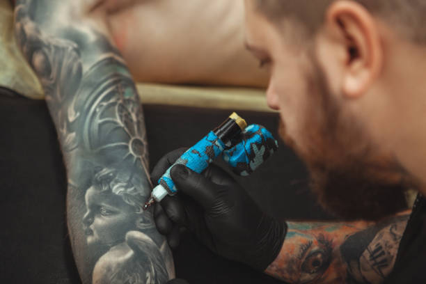 istock Man getting new tattoo by professional tattooist 1152975014