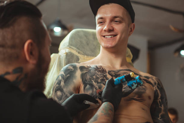 istock Man getting new tattoo by professional tattooist 1152975024