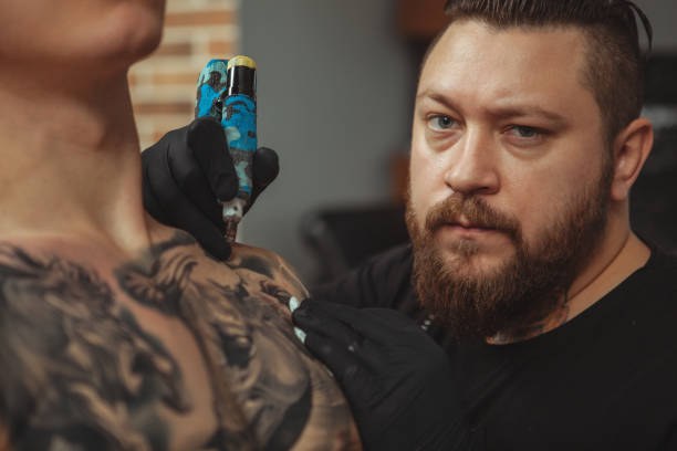 istock Man getting new tattoo by professional tattooist 1152975058