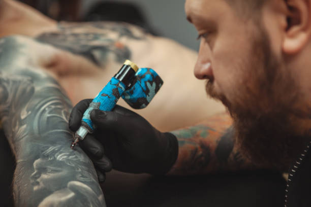 istock Man getting new tattoo by professional tattooist 1152975061