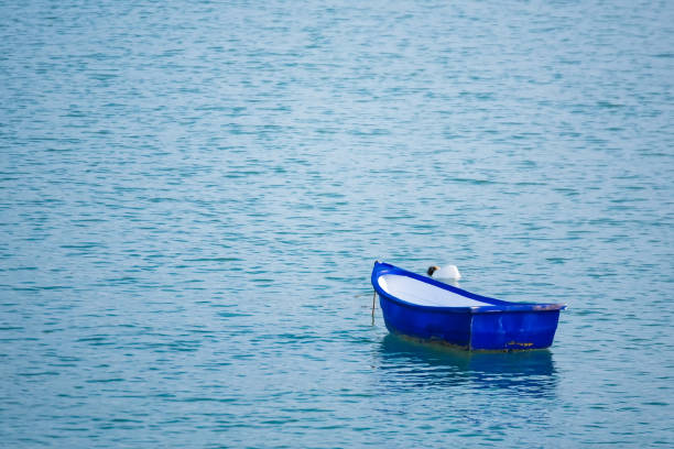 istock Boat resting inside the harbor at low tide. 1152975131
