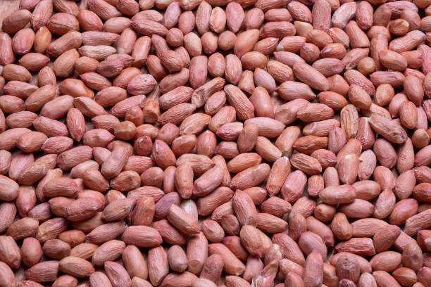 istock peanuts scattered on a wooden table. Close-up peanuts beans. 1152975389