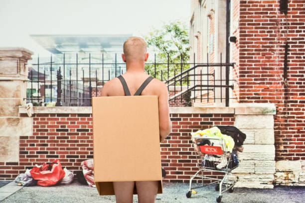 istock Poverty man in box shirtless looking away 1152976034