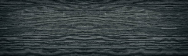 Old cracked black painted solid wooden surface wide texture. Dark gray wood panoramic retro background