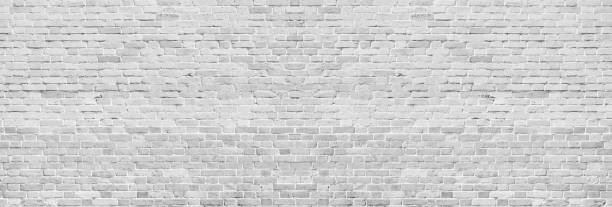 Wide white washed brick wall texture. Rough light gray vintage brickwork. Whitewashed panoramic background Wide white washed brick wall texture. Rough light gray vintage brickwork. Whitewashed panoramic background brick wall photos stock pictures, royalty-free photos & images
