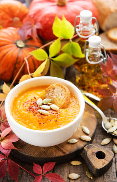 istock Bowl of pumpkin soup on rustic wooden background 1152977697