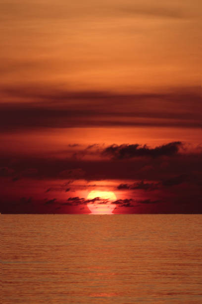 istock Big sun red orange and black clouds 1152979976