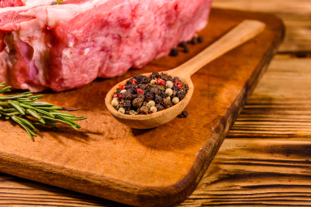 istock Raw pork ribs with spices and rosemary on a cutting board 1152980722