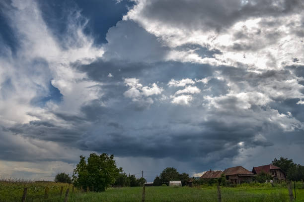 istock Isolated thunderstorm cloud over a scenic romanian village 1152985713