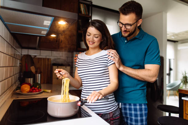 istock Young couple cooking together at home 1152985795