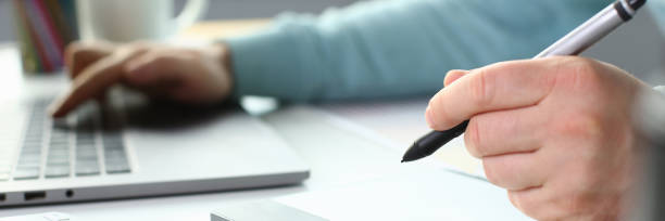 istock A young designer holds a pen from a tablet in his 1152987585