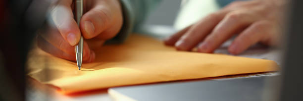 istock Male hand holding silver pen 1152987612