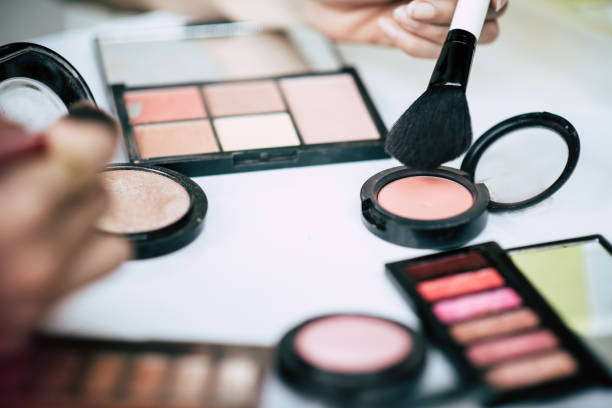 istock Women doing makeup with brush and cosmetic 1152987661