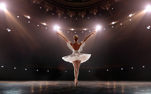 Ballet. Classical ballet performed by a couple of ballet dancers on the stage of the opera house.