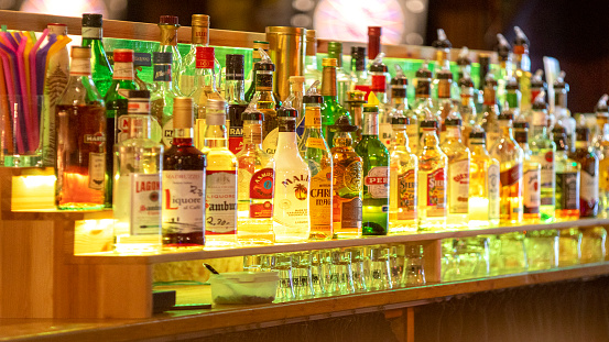 Various alcohol bottles lit in the bar